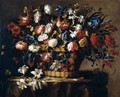 Still Life Of Roses, Irises, Morning Glory, Hyacinths, Chrysanthemums And Carnations In A Wicker Basket, Set Upon A Stone Ledge, Together With A Stem Of Lilies, Butteflies, Dragonflies And A Snail - Juan De Arellano