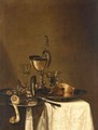 Still Life Of A Nautilus Cup, An Overturned Tazza, A Partially Eaten Pie In A Pewter Bowl And A Knife, Together With Two Wine Glasses, And Olives And A Peeled Lemon In Pewter Dishes, All Arranged Upon A Table Top Partly Draped With A White Cloth - (after) Willem Claesz. Heda