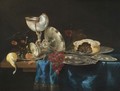 Still Life With A Nautilus Cup, A Meat Pie, A Bunch Of Grapes, Some Pewter Plates And A Partly-Peeled Lemon - Gerrit Willemsz. Heda