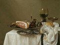 A Still Life With A Roemer, A Silver Tazza, A Fluted Wine-Glass, A Mustard Jar, A Ham And A Partly Peeled Lemon On Pewter Dishes - Willem Claesz. Heda